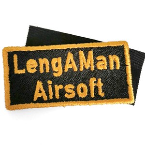 a black and yellow patch with the text "LengMan Airsoft" embroidered on it.