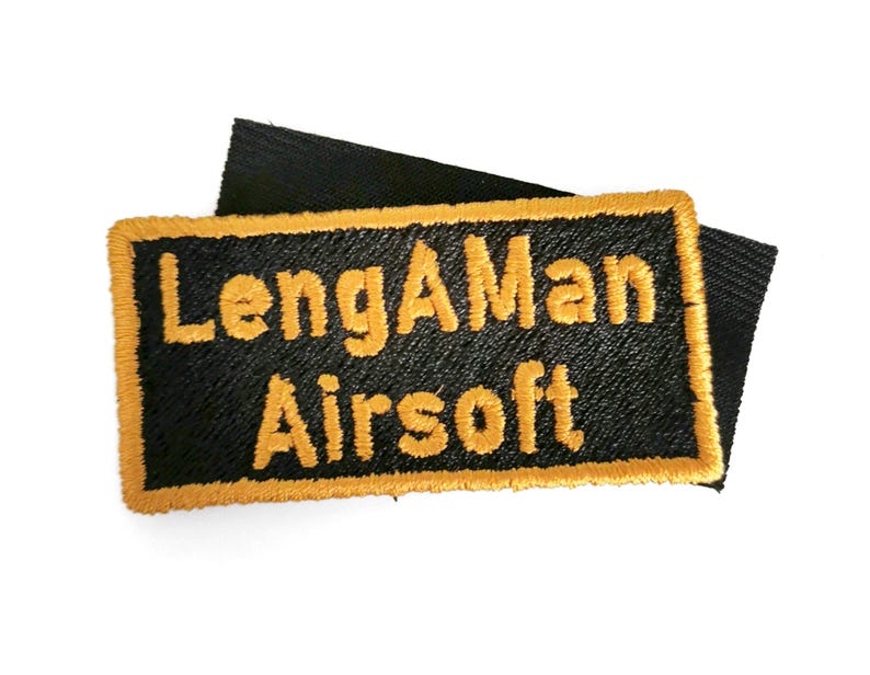a black and yellow patch with the text "LengMan Airsoft" embroidered on it.