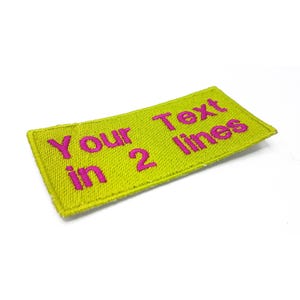 A yellow patch with the text "Your Text in 2 lines" printed on it in pink.
