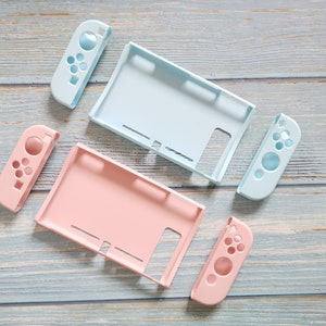 May include: Two sets of Nintendo Switch console shell replacements. One set is light blue and the other is pink. Each set includes a console back, two joy-con controllers, and a screen cover.