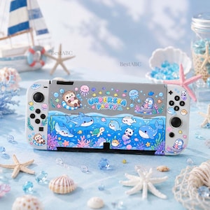 May include: A white gaming console featuring a colorful under-the-sea theme with cartoon marine animals including a whale, shark, turtle, and otter. The text "UNDERSEA PARTY" is printed in blue letters across the center of the device.