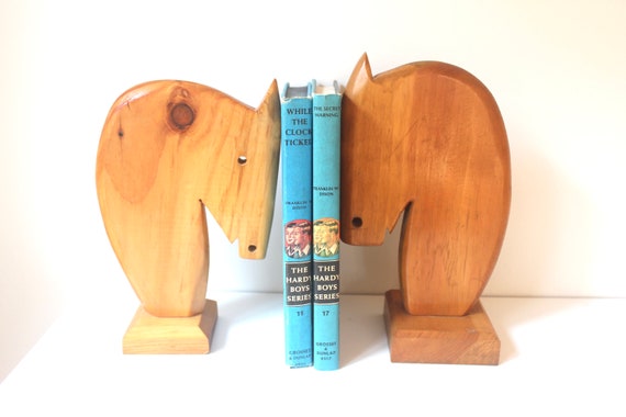 Deliberately mismatched carved wood horse head bookends with that unmistakable 70s MCM soul — the kind of thing you'd find in a cool uncle's study and never stop thinking about.
