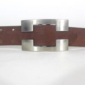 34”-38” Wide Brown Leather Belt with a Large Silver Metal Buckle