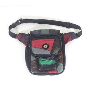 May include: A multi-coloured patchwork fanny pack with a black adjustable strap. The bag features leather patches in red, green, blue, and brown. It has a zipped main compartment and a small front pocket.