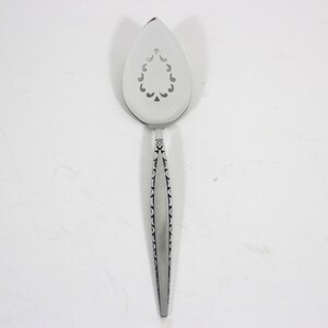 May include: A silver cake server with a decorative handle and a pierced, teardrop-shaped blade.