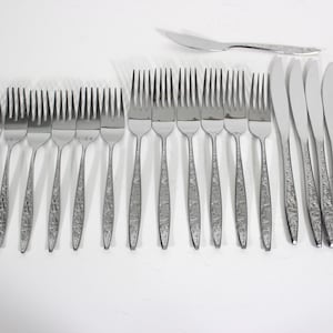 May include: A set of 18 silver-toned cutlery pieces, including forks and knives. The cutlery has a textured, hammered finish.