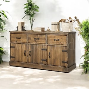 May include: A rustic wooden sideboard with three drawers and two doors. The sideboard has a dark brown stain and black metal hardware.