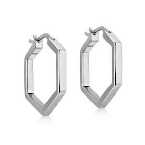 May include: A pair of silver hexagonal hoop earrings. The earrings are made of 925 sterling silver.