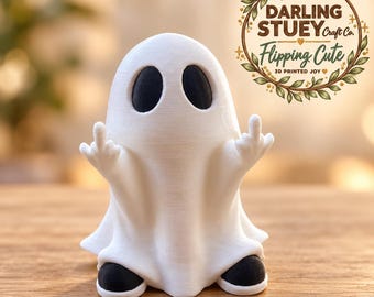 May include: A white 3D printed ghost figurine with black oval eyes and black feet, depicted with both arms raised and middle fingers extended. The text DARLING STUEY Craft Co. Flipping Cute 3D PRINTED JOY is visible in the upper right corner.