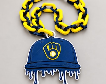 May include: A necklace featuring a thick, chunky chain with alternating yellow and navy blue plastic links. Attached to the chain is a large, flat pendant shaped like a navy blue baseball cap with a yellow glove and ball logo.