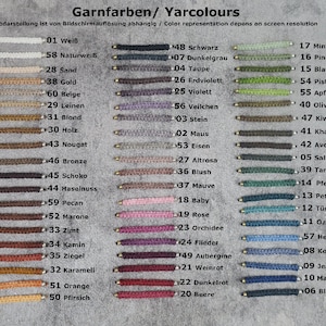 May include: A chart of yarn colours with corresponding numbers and names in German and English. The yarn colours are arranged in rows, with each row containing a different colour. The colours range from white to black, with shades of brown, green, blue, red, and purple in between.