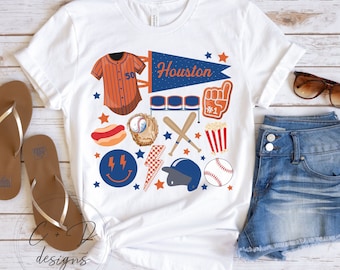 May include: White t-shirt with a baseball theme design. The design includes a baseball jersey, baseball bats, a baseball glove, a baseball cap, a hot dog, popcorn, a pennant that says "Houston", and stars.