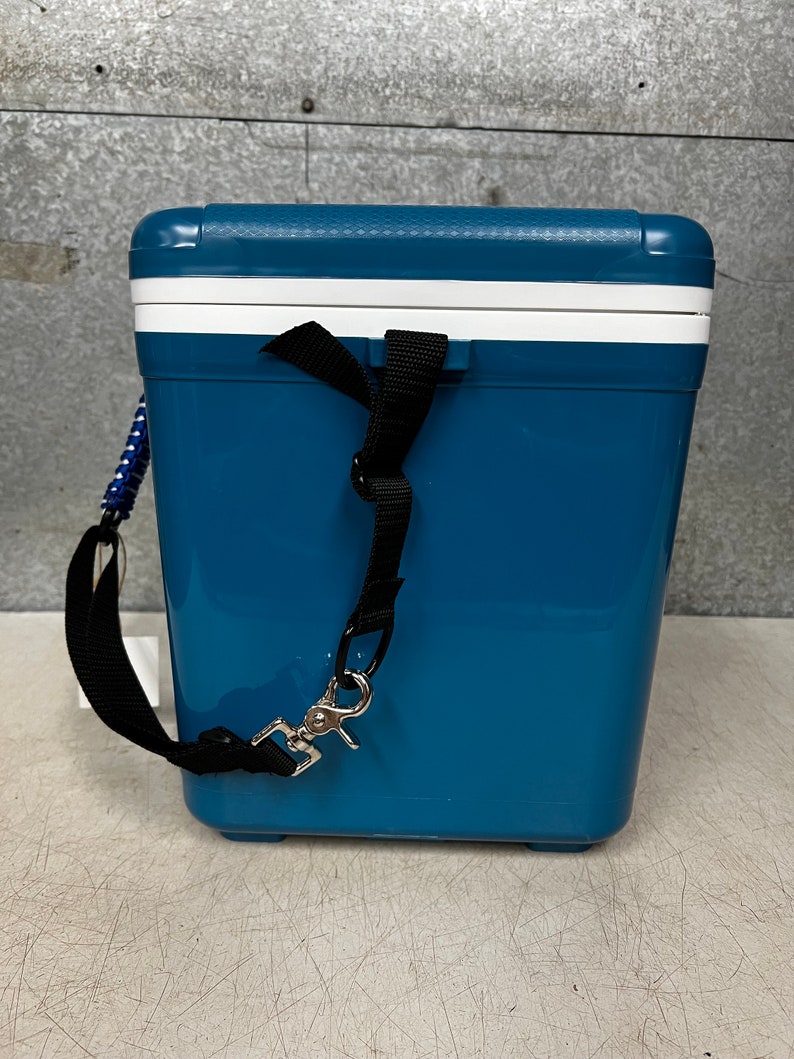 May include: A blue cooler with a white lid and a black strap. The cooler has a silver hook on the strap.