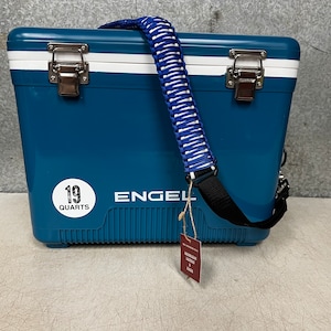 May include: A blue Engel cooler with a white stripe and a black strap. The cooler has a white sticker that says "19 Quarts".