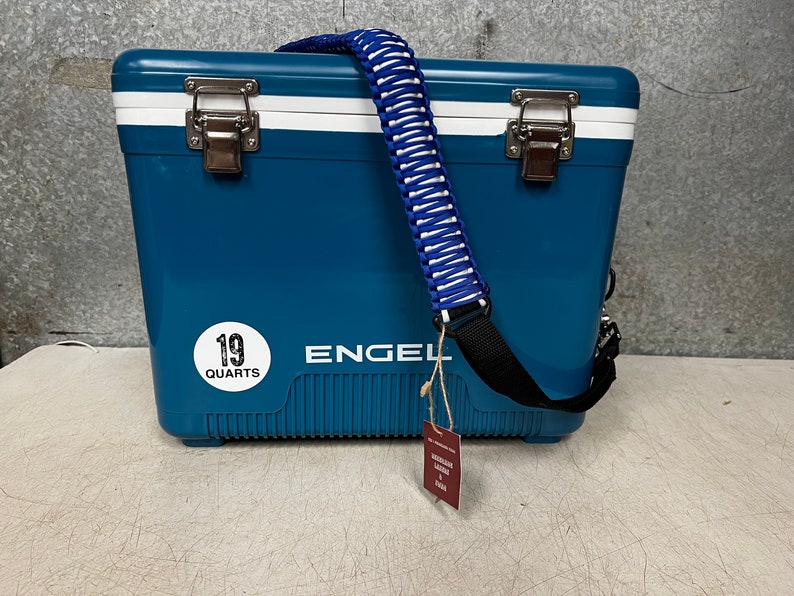 May include: A blue Engel cooler with a white stripe and a black strap. The cooler has a white sticker that says "19 Quarts".