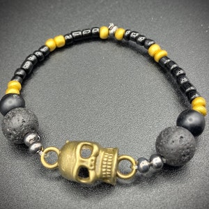 Metal skull stretch bracelet with lava stones.
