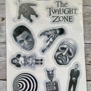 May include: A sheet of clear stickers featuring characters and imagery from the classic television series "The Twilight Zone". The stickers include a man with three eyes, a doll, a man in a suit, a devil head, a face with a frown, a swirling black and white circle, and a man floating in space.