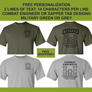May include: Military green and grey short-sleeve t-shirts featuring black graphic prints of a castle icon with the text SAPPER or COMBAT ENGINEER and a space for custom text. The designs appear on the front left chest and the full back.