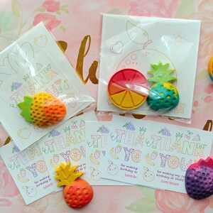 May include: Thank you cards with fruit-shaped crayons. The cards have a colorful design with the words "Thank You" written in a fun font. The crayons are shaped like a strawberry, pineapple, orange, and watermelon.