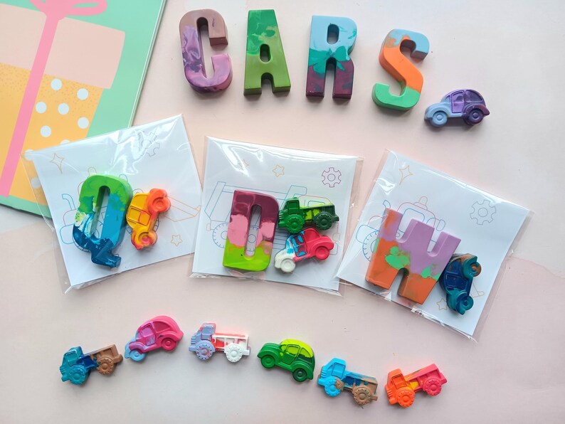 May include: A set of colorful crayon letters spelling out "CARS" with a variety of small crayon cars in individual bags. Each bag has a different letter and a different car design.