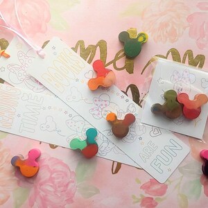May include: Three colorful bookmarks with a mouse character design and the text "Reading Time", "Books", and "Are Fun".  The bookmarks are packaged with small, colorful crayons shaped like a mouse head.