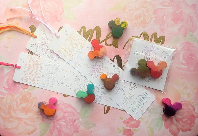 May include: Three colorful bookmarks with a mouse character design and the text "Reading Time", "Books", and "Are Fun".  The bookmarks are packaged with small, colorful crayons shaped like a mouse head.