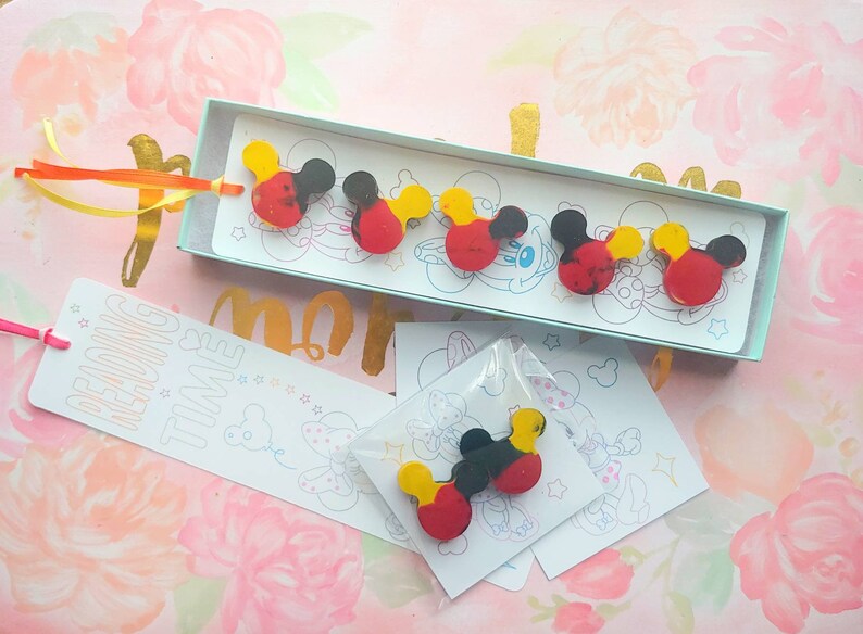 May include: A set of six colorful Mickey Mouse head shaped bookmarks. The bookmarks are red, yellow, and black with a white background. The bookmarks are packaged in a clear plastic bag with a white card that says "Reading Time".