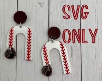 May include: A pair of white and red baseball-themed earrings with a brown accent. The earrings are shaped like an arch with a baseball stitch pattern. Each earring has a small brown baseball glove charm hanging from the bottom.