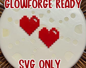Puede incluir: Dos formas de corazón pixeladas rojas sobre un fondo blanco con el texto "Glowforge Ready" y "SVG Only" en rojo.