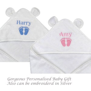 May include: Two white hooded baby towels with bear ears. One towel is embroidered with the name "Harry" in blue and blue footprints. The other towel is embroidered with the name "Amy" in pink and pink footprints. The towels are a baby gift.