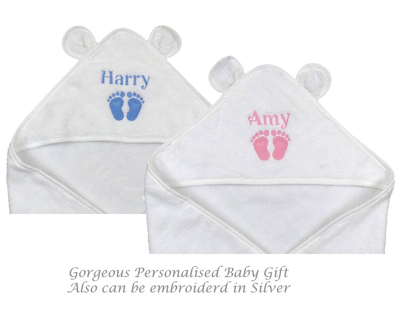 May include: Two white hooded baby towels with bear ears. One towel is embroidered with the name "Harry" in blue and blue footprints. The other towel is embroidered with the name "Amy" in pink and pink footprints. The towels are a baby gift.