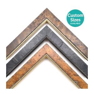 May include: Three V-shaped picture frame corner samples arranged vertically. The top and bottom frames feature a brown burl wood grain finish, while the middle frame is matte black. Each frame includes a thin gold-toned rope-style inner trim.