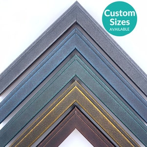 May include: A collection of metallic picture frame corners in various colors, including gray, blue, green, gold, and brown. The frames are arranged in a layered pattern, showcasing their different hues and textures. The image includes a teal circle with the text "Custom Sizes AVAILABLE."