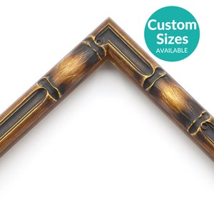 May include: A close-up of a corner of a dark brown wood picture frame with a bamboo design. The frame has a gold-colored finish. The text "Custom Sizes Available" is in a teal circle.