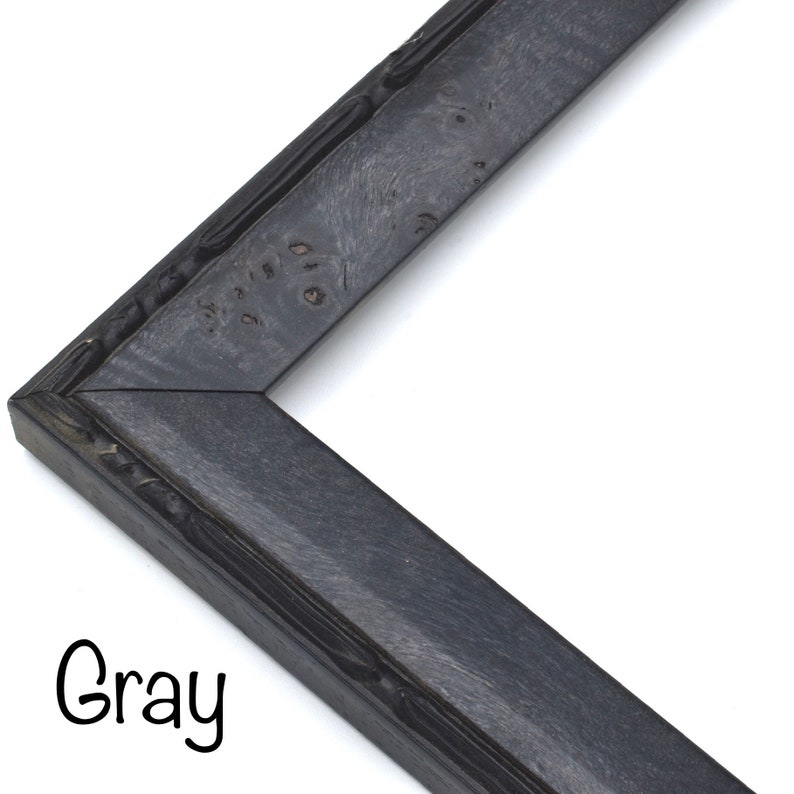 May include: A close-up of a gray picture frame with a textured, wood-like finish. The frame is made of a sturdy material and has a simple, elegant design.