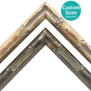 May include: Two picture frames with a rustic, wood-like finish. The top frame is a light brown with a darker brown wood grain. The bottom frame is a dark brown with a silver-colored wood grain. Both frames have a beveled edge.
