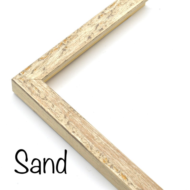 May include: A close-up of a corner of a picture frame with a distressed, sand-colored finish. The frame is made of wood and has a subtle, textured surface.