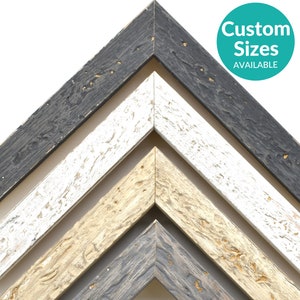May include: A collection of wooden picture frame samples in various colors, including black, white, beige, and gray. The frames have a distressed, rustic appearance. The image includes a teal circle with the text "Custom Sizes AVAILABLE".
