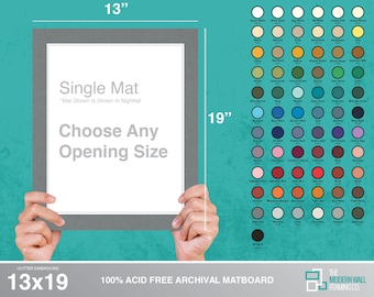 May include: A 13x19 inch single mat board with a gray mat and a white core. The mat board is 100% acid free archival. The mat board is shown in the color Nightfall. The text "Choose Any Opening Size" is printed on the mat board. The mat board is held by two hands.