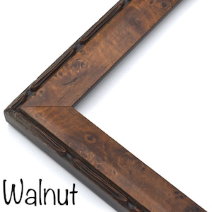 May include: Close-up of a walnut wood picture frame with a decorative edge. The frame has a rich brown color and a natural wood grain.