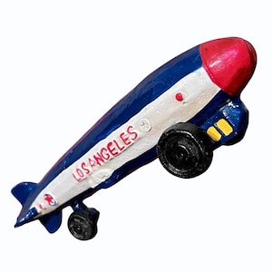 May include: A handmade wooden sign with the text "Welcome" in a playful font. The sign features a distressed white background and a dark stained wooden frame, perfect for a front door or entryway.