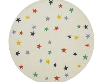 May include: A round, off-white rug with a scattered pattern of colorful stars. The stars are in shades of red, yellow, blue, green, and gray. The rug is a soft, decorative floor covering.