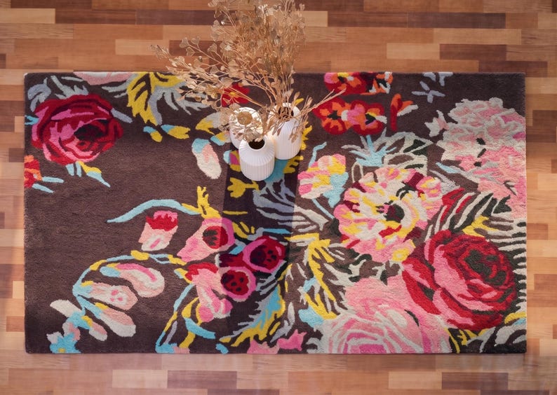 Overhead perspective of a colorful floral hand-tufted runner rug placed on a dark wood floor.