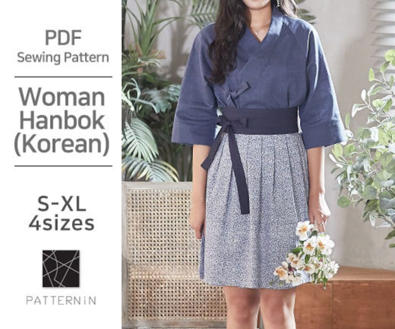May include: A navy blue Hanbok, a traditional Korean garment, featuring a wrap top and a floral print skirt. The image includes the text "PDF Sewing Pattern" and "Woman Hanbok (Korean)". The pattern is available in sizes S-XL.