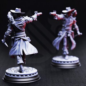 May include: Two detailed figurines of a figure in a hat and long coat, holding a gun and a knife. The figures are on circular bases with intricate designs. The color is a muted gray, with highlights and shadows adding depth.