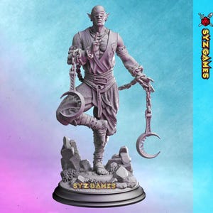 May include: A detailed statue of a blindfolded figure in a meditative pose, holding crescent-shaped objects connected by chains. The figure is standing on a rocky base, with the text "SYZ GAMES" visible. The statue is in shades of gray.