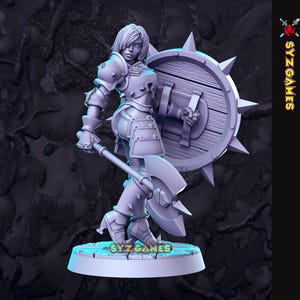 May include: A gray plastic miniature figurine of a female warrior with blonde hair, wearing armor and holding a large axe and a spiked shield. The figurine is standing on a round base.
