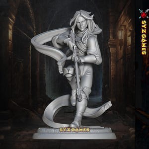 May include: A grey figurine of a character holding a rifle, posed dynamically. The figure has long hair and is wearing detailed armour. The base of the figurine has the text "SYZ GAMES". The background is a blurred, dark architectural setting.