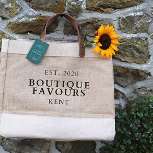 Natural Hessian Market Shopper Bag with leather handles, with the personalisation 'EST. 2020, BOUTIQUE FAVOURS, KENT' 
printed in black matte vinyl.