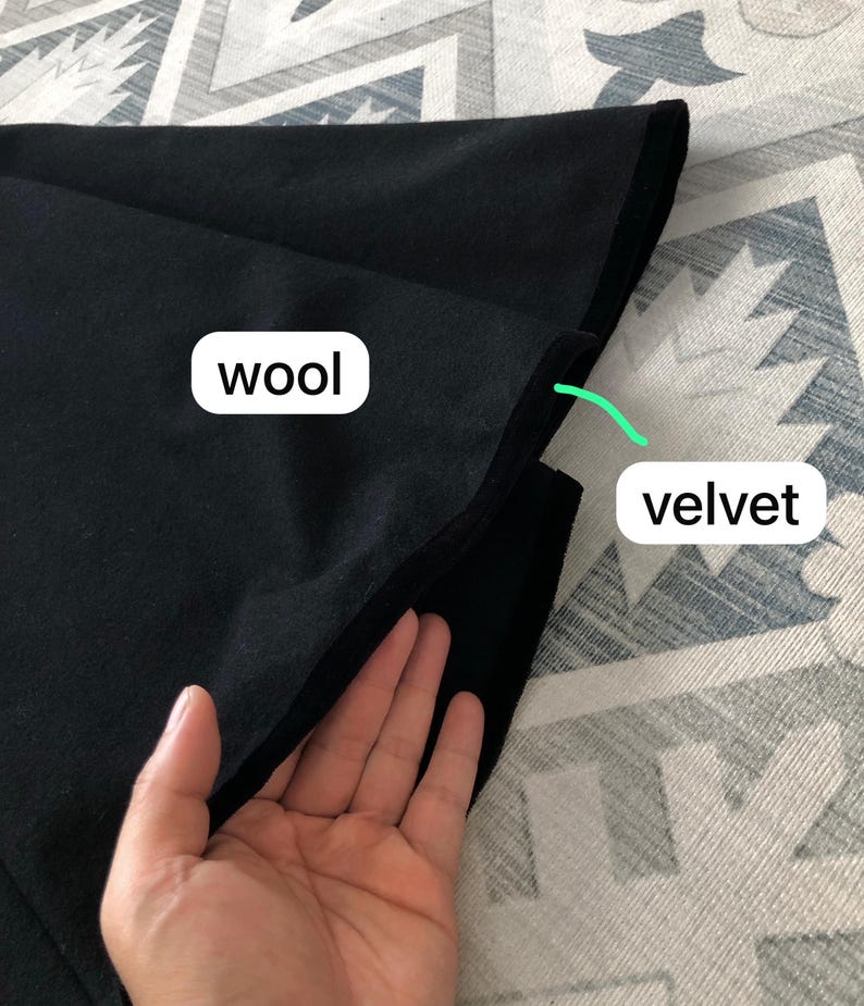 May include: A black fabric swatch with two different textures. The top layer is wool and the bottom layer is velvet.